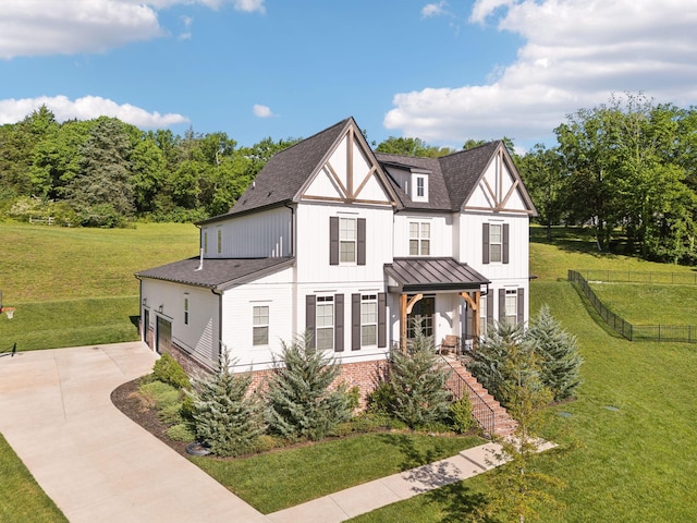 tudor home with concrete driveway, board and batten siding, a standing seam roof, a shingled roof, and a garage