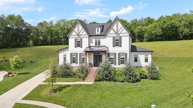 7214 Neills Branch Dr, College Grove, TN 37046 - tudor-style house with board and batten siding, a front yard, and stairs