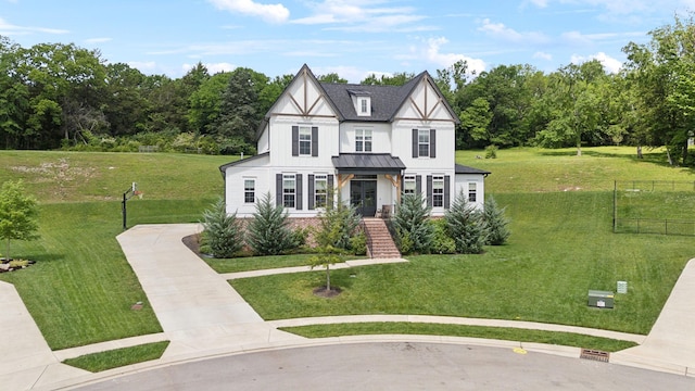 7214 Neills Branch Dr, College Grove, TN 37046 - tudor-style house featuring a standing seam roof, a front yard, metal roof, and board and batten siding