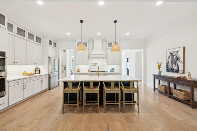 7214 Neills Branch Dr, College Grove, TN 37046 - kitchen with stainless steel appliances, premium range hood, light countertops, tasteful backsplash, and glass insert cabinets