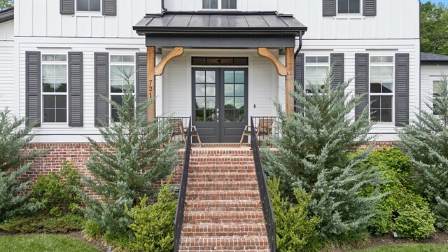 7214 Neills Branch Dr, College Grove, TN 37046 - property entrance with a standing seam roof, metal roof, board and batten siding, a porch, and french doors