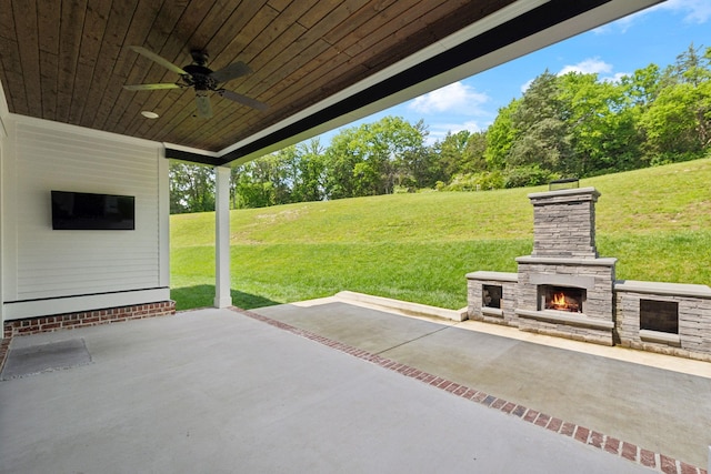 7214 Neills Branch Dr, College Grove, TN 37046 - view of patio featuring ceiling fan, an outdoor stone fireplace, and view of wooded area