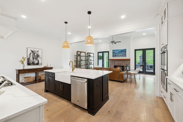 7214 Neills Branch Dr, College Grove, TN 37046 - kitchen with stainless steel appliances, a sink, white cabinets, light wood-style flooring, and recessed lighting