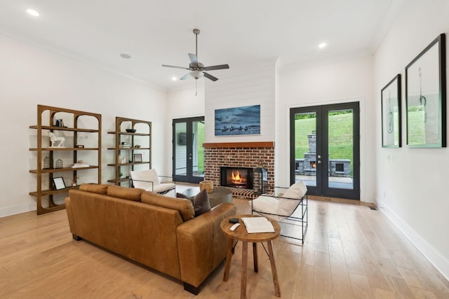 7214 Neills Branch Dr, College Grove, TN 37046 - living room featuring light wood-style floors, a fireplace, ceiling fan, baseboards, and crown molding