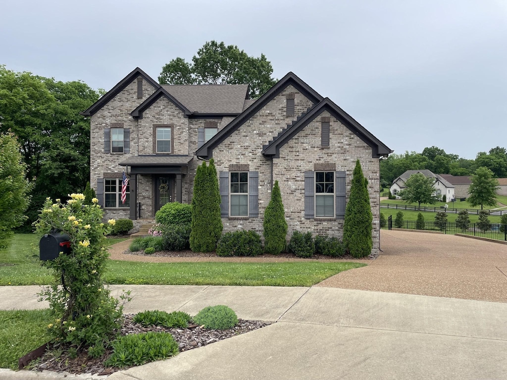 view of front of property with fence and brick siding