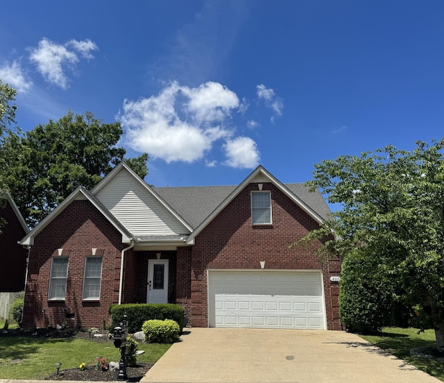 view of front of property with concrete driveway, brick siding, and a garage