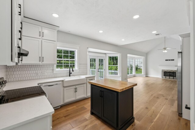503 Mable Mason Cv, La Vergne, TN 37086 - kitchen with wood counters, a sink, white dishwasher, open floor plan, and a ceiling fan
