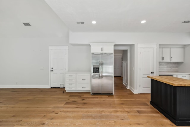 503 Mable Mason Cv, La Vergne, TN 37086 - kitchen with stainless steel fridge with ice dispenser, butcher block countertops, white cabinetry, baseboards, and light wood-style floors