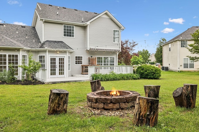 503 Mable Mason Cv, La Vergne, TN 37086 - back of house featuring an outdoor fire pit, french doors, central AC, roof with shingles, and a lawn