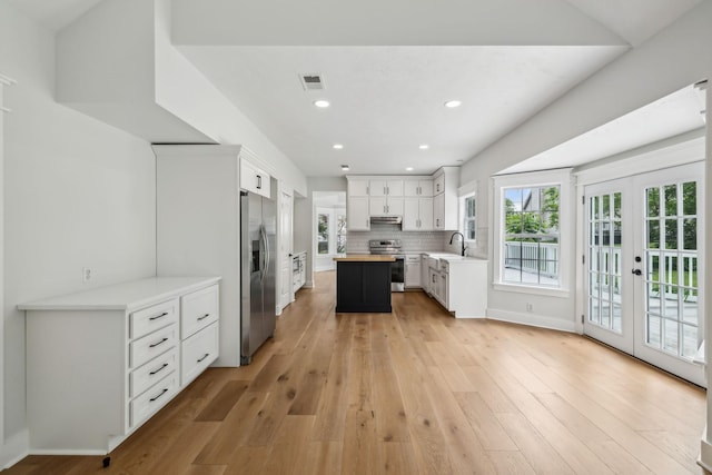 503 Mable Mason Cv, La Vergne, TN 37086 - kitchen with appliances with stainless steel finishes, french doors, wood counters, a sink, and light wood-style flooring