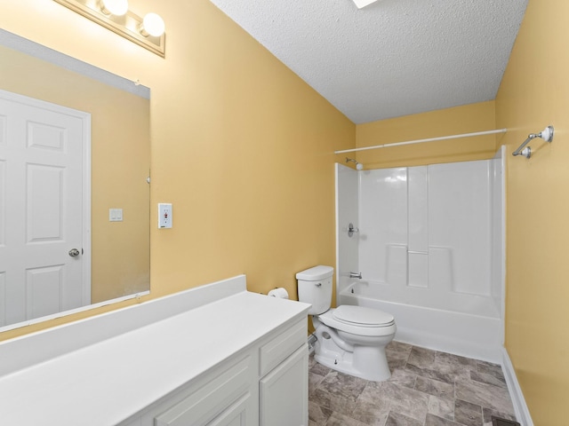 bathroom with toilet, a textured ceiling, vanity, tub / shower combination, and baseboards