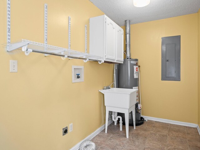 clothes washing area with cabinet space, electric panel, baseboards, electric dryer hookup, and gas water heater