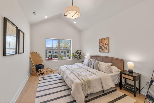 bedroom with light wood-style flooring, baseboards, recessed lighting, and high vaulted ceiling