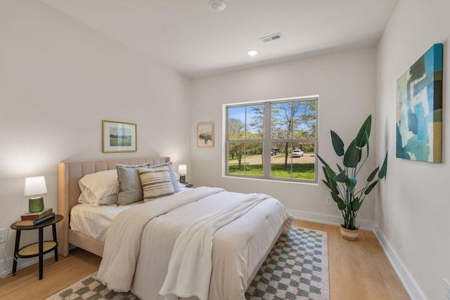 bedroom with light wood-style flooring, recessed lighting, and baseboards