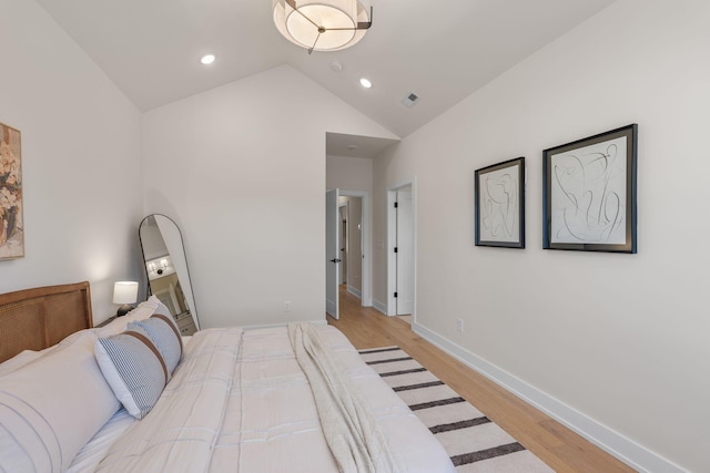 bedroom with light wood-style flooring, vaulted ceiling, baseboards, and recessed lighting