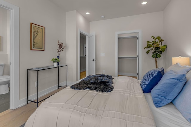 bedroom with light wood-style flooring, recessed lighting, a closet, and baseboards