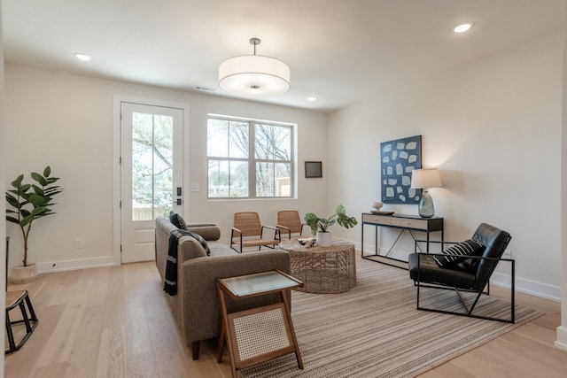 sitting room with light wood finished floors, baseboards, and recessed lighting
