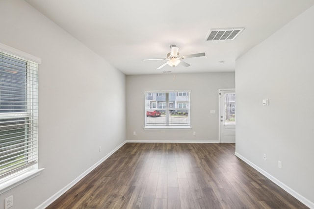unfurnished room with ceiling fan, dark wood-style floors, and baseboards
