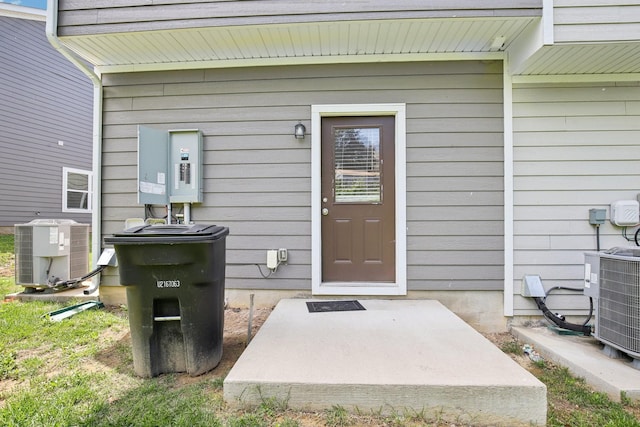 view of exterior entry with central air condition unit