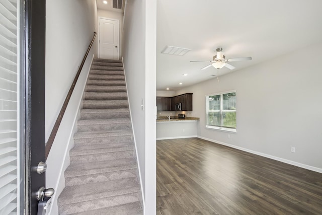 stairs featuring wood finished floors, ceiling fan, baseboards, and recessed lighting