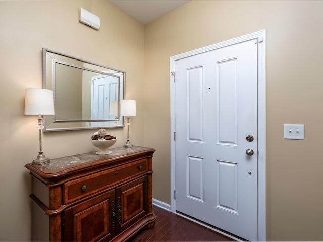 entryway featuring dark wood-style floors and baseboards
