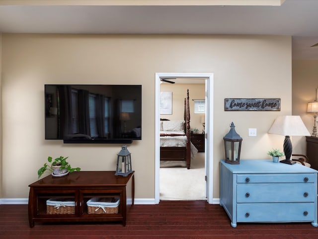 living area with dark wood-style floors and baseboards