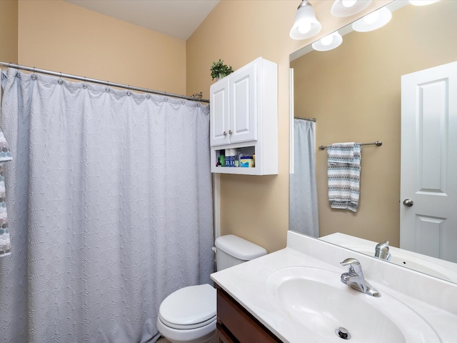 bathroom featuring toilet and vanity
