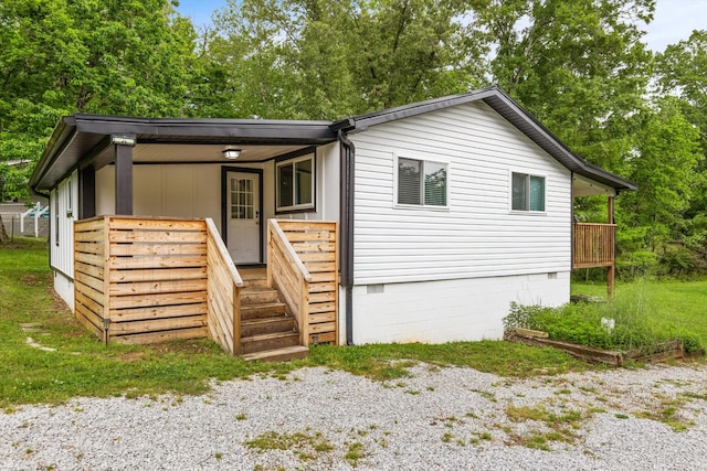 237 Windsor Ct, Spring City, TN 37381 - view of front of house featuring crawl space, covered porch, and view of wooded area