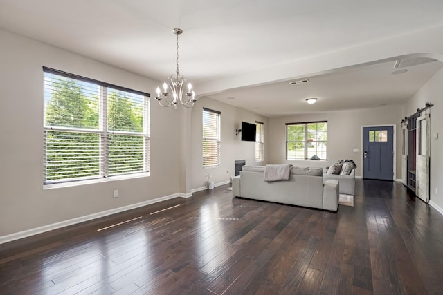 2303 Dewey Dr, Spring Hill, TN 37174 - living area featuring a chandelier, baseboards, dark wood finished floors, a barn door, and arched walkways
