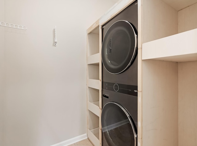 2303 Dewey Dr, Spring Hill, TN 37174 - laundry area with stacked washer and clothes dryer and baseboards