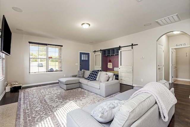 2303 Dewey Dr, Spring Hill, TN 37174 - living room featuring arched walkways, dark wood-style floors, and baseboards