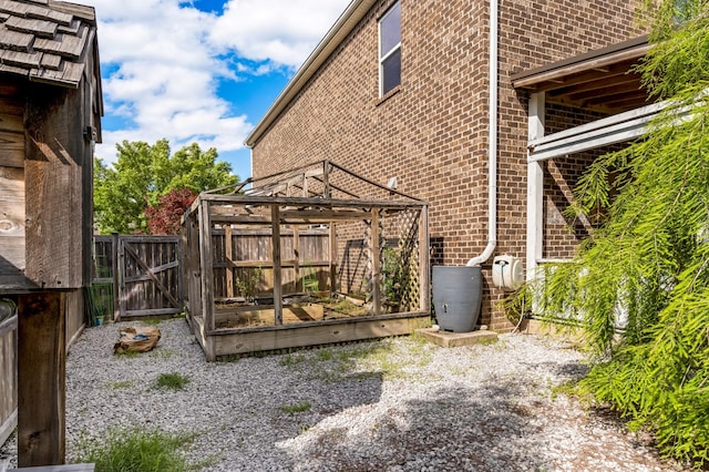 2303 Dewey Dr, Spring Hill, TN 37174 - view of home's exterior featuring brick siding, a gate, and fence