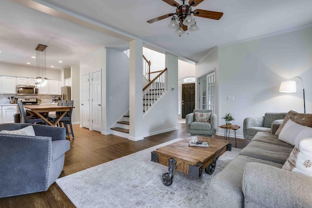 2025 Lewisburg Pike, Franklin, TN 37064 - living room featuring a ceiling fan, stairs, dark wood-type flooring, baseboards, and crown molding