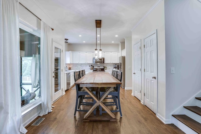 2025 Lewisburg Pike, Franklin, TN 37064 - dining space with dark wood-style floors, crown molding, stairs, and baseboards