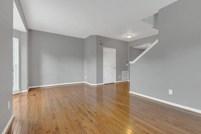 spare room featuring light wood-style flooring and baseboards