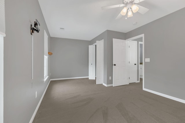 unfurnished bedroom with carpet floors, baseboards, and ceiling fan