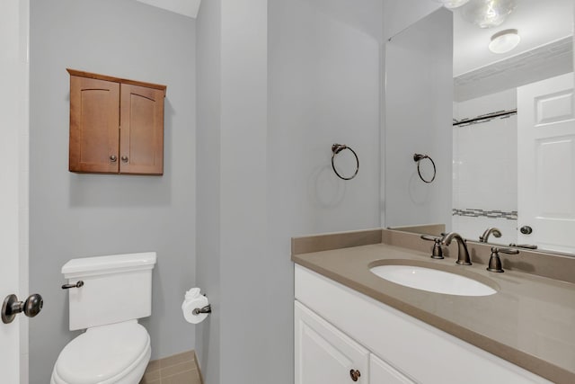 full bathroom with toilet, vanity, a shower, tile patterned floors, and baseboards