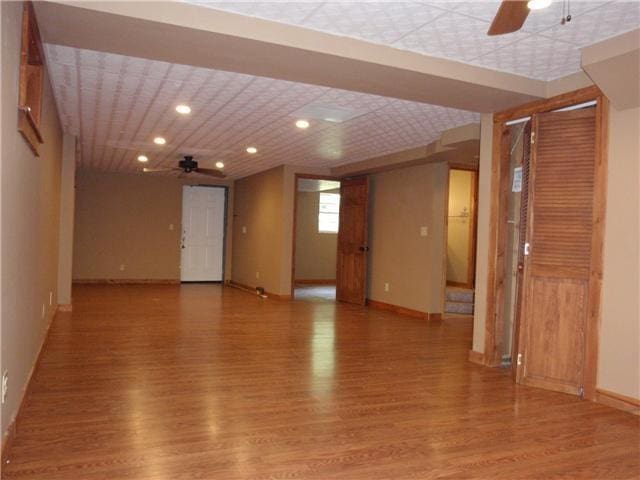 unfurnished room featuring ceiling fan, light wood-style floors, baseboards, and recessed lighting