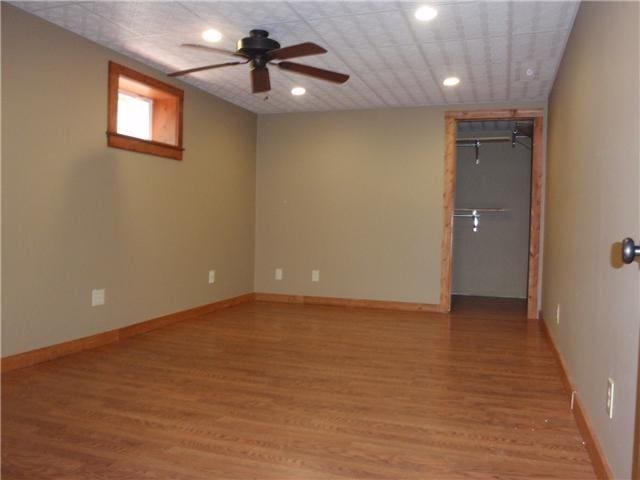 spare room with a ceiling fan, light wood-type flooring, recessed lighting, and baseboards