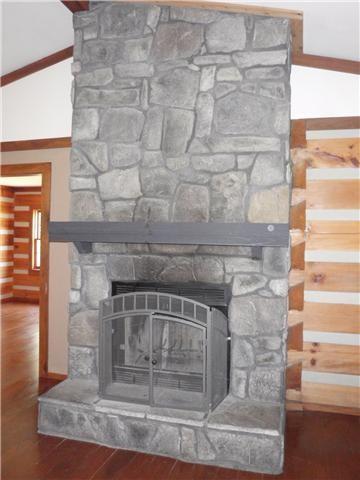 detailed view of a fireplace and wood finished floors
