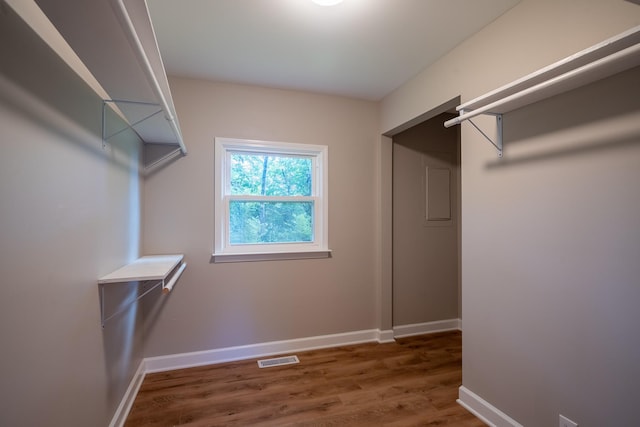 spacious closet with wood finished floors