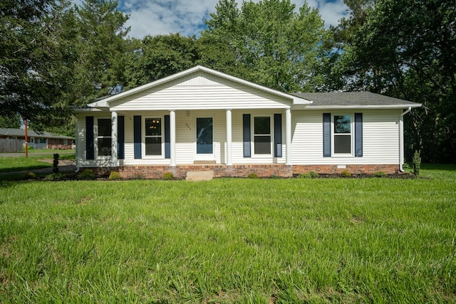 ranch-style home featuring a porch, a front yard, and roof with shingles