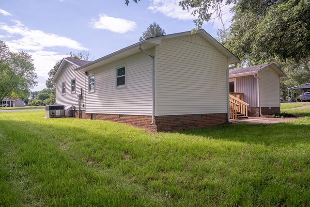 view of property exterior with crawl space and a yard