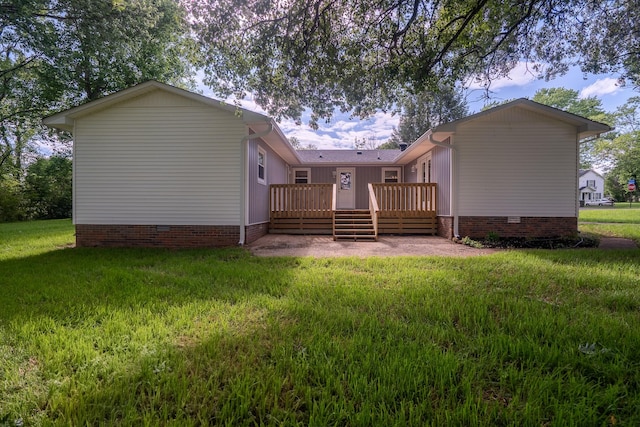rear view of property featuring crawl space, a wooden deck, and a yard