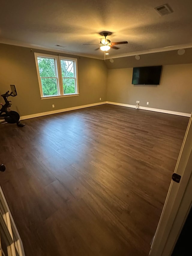 empty room with dark wood finished floors, baseboards, and a ceiling fan