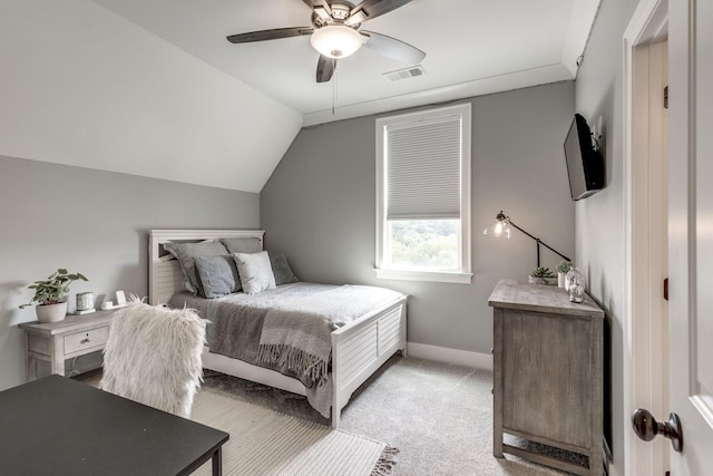 bedroom with light carpet, vaulted ceiling, baseboards, and ceiling fan