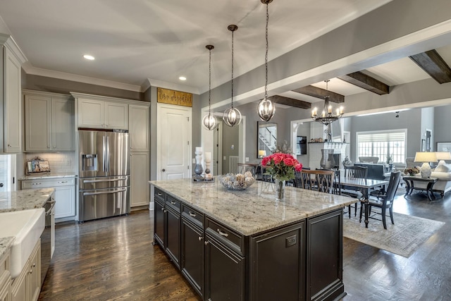 kitchen with stainless steel refrigerator with ice dispenser, a chandelier, open floor plan, dark wood-style floors, and decorative backsplash