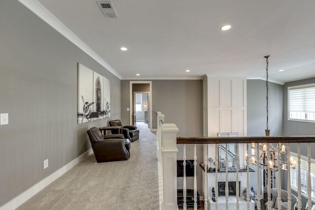 hallway featuring recessed lighting, baseboards, crown molding, a chandelier, and carpet floors