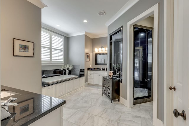 bathroom featuring crown molding, vanity, a garden tub, marble finish floors, and recessed lighting