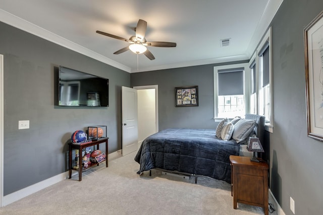 bedroom with carpet flooring, crown molding, baseboards, and ceiling fan
